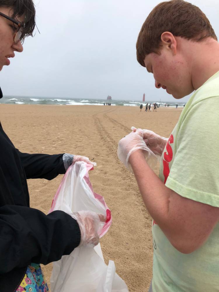 Student examines object found on the beach